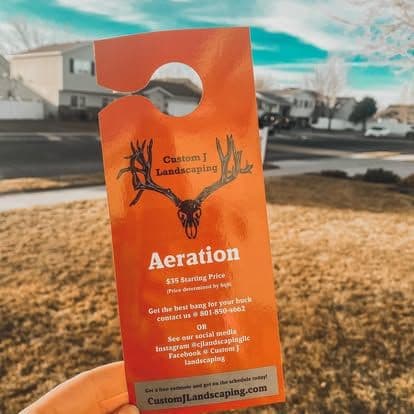 Red door hanger for Custom J Landscaping promoting aeration services starting at $35.